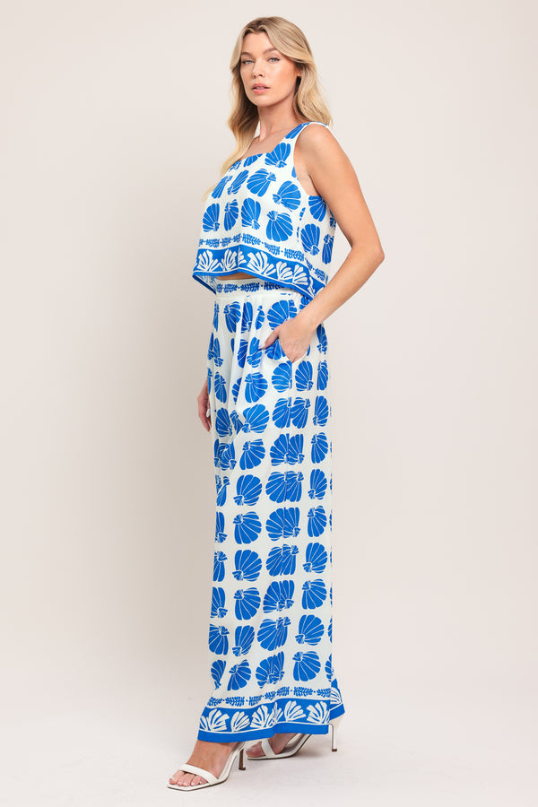Woman wearing a blue and white patterned top and pant set | Flying Tomato
