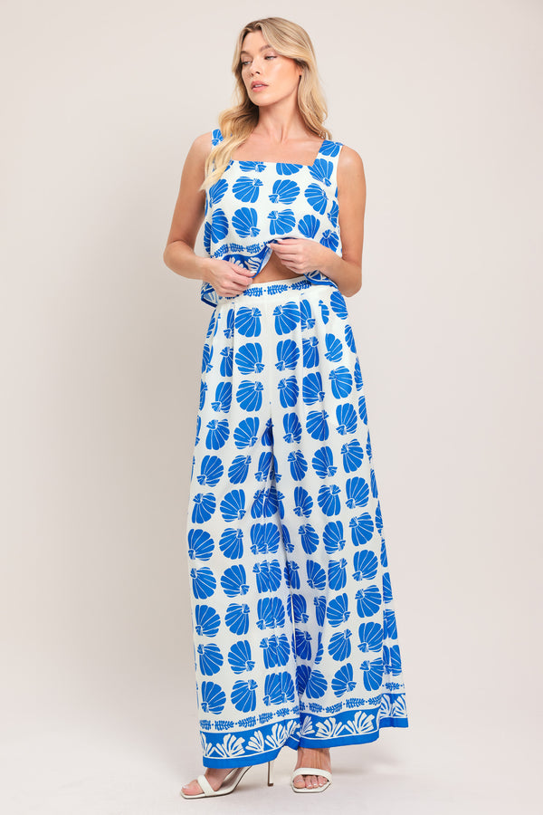 Woman wearing a blue and white patterned top and pant set | Flying Tomato