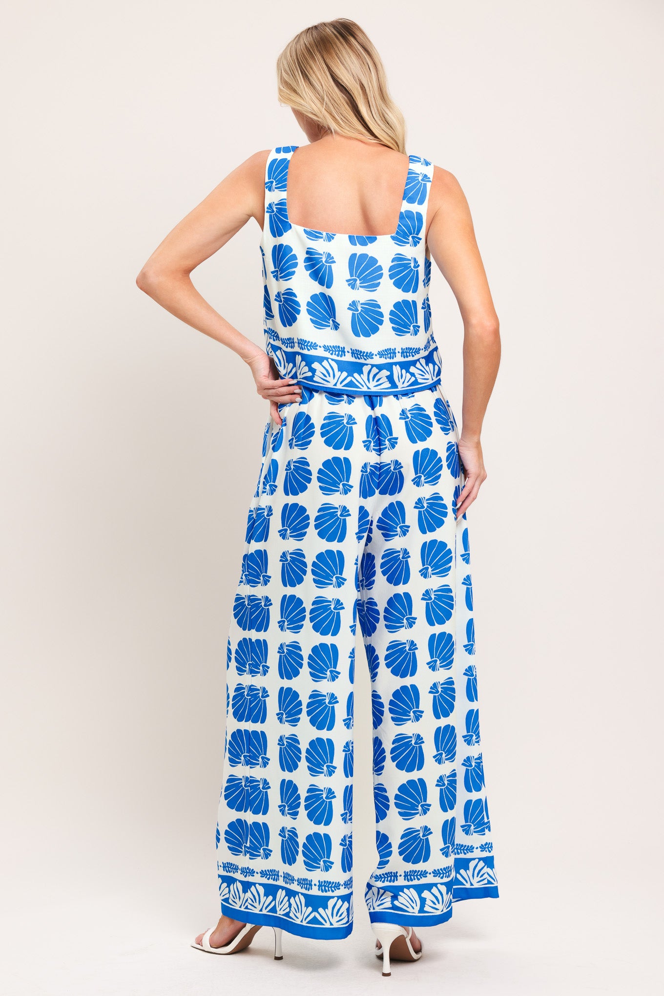 Woman wearing a blue and white patterned top and pant set | Flying Tomato