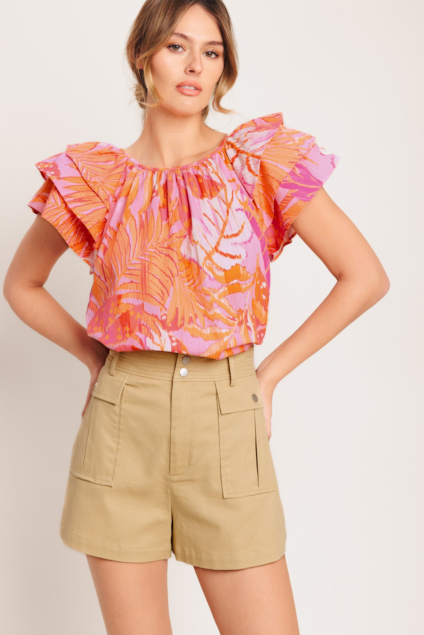 A printed woven top featuring round neckline, layered flutter sleeve and back neck button closure

Details:

Self : 100% Cotton

Size &amp; Fit

- Model is 5`8" And Wearing Size Small
- Measurements Taken From Size Small
- Approx. Length: 26"
