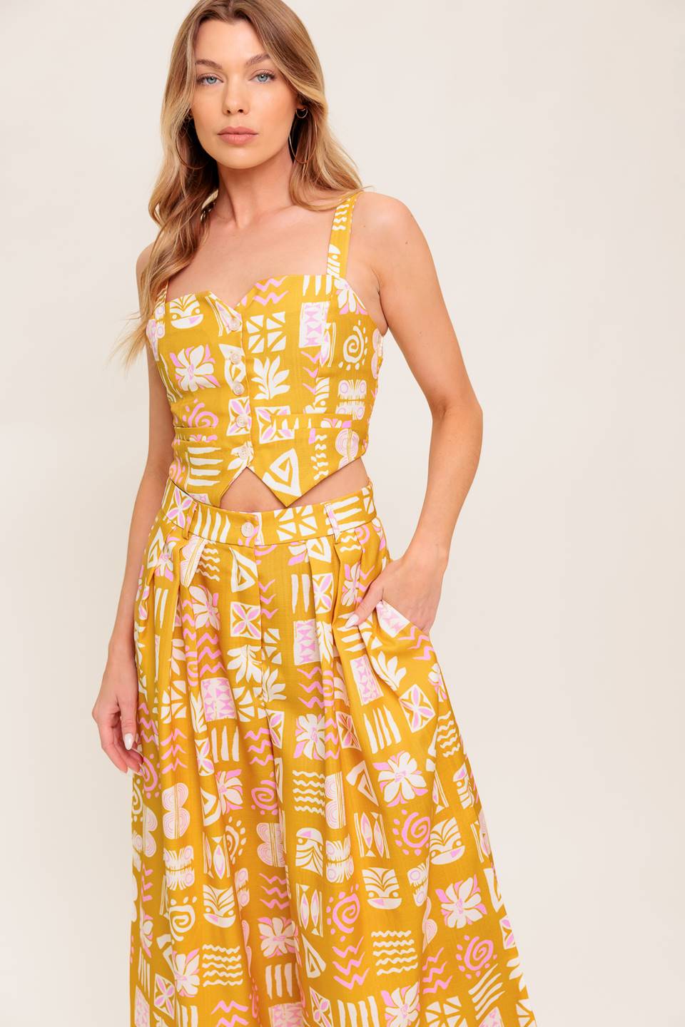 A printed woven top and pant set. Top featuring front button down with smocked back bodice. Pant featuring front closure and wide leg.