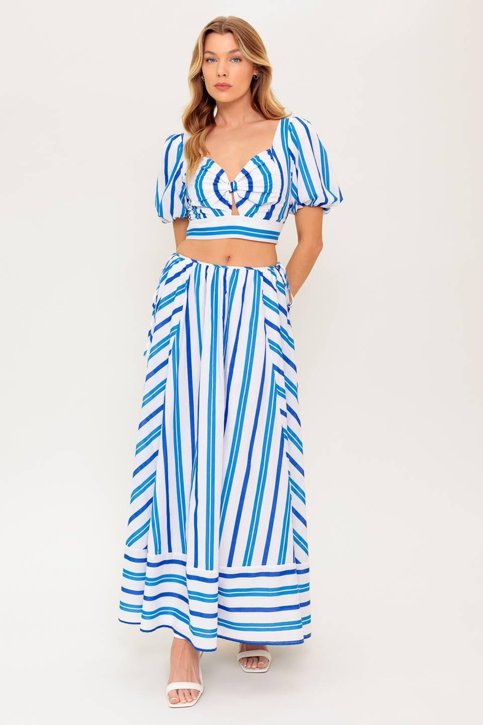 A striped woven top and skirt set. Top featuring sweetheart neckline with center bow and cut out, short puff sleeve and smocked back bodice. Circle skirt featuring side tie and zipper closure