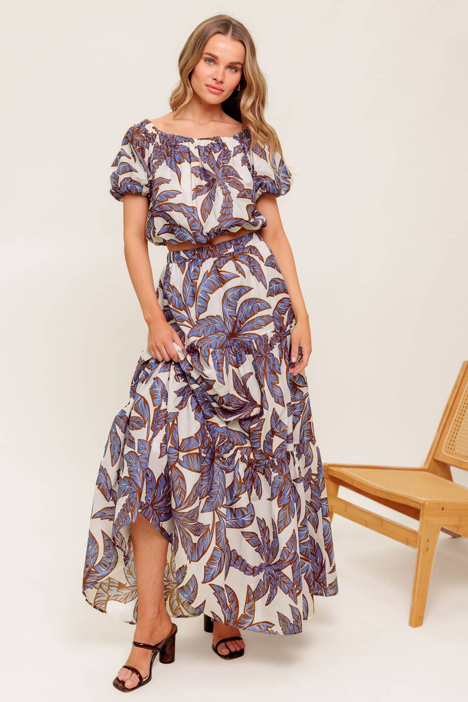 A printed woven top featuring on/off shoulder neckline, short puff sleeve and elasticized waist.