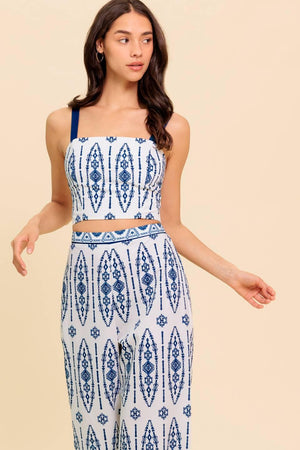 A printed woven top and pant set. Crop top featuring straight neckline, straps and smocked back bodice. Pant featuring wide leg and side zipper closure