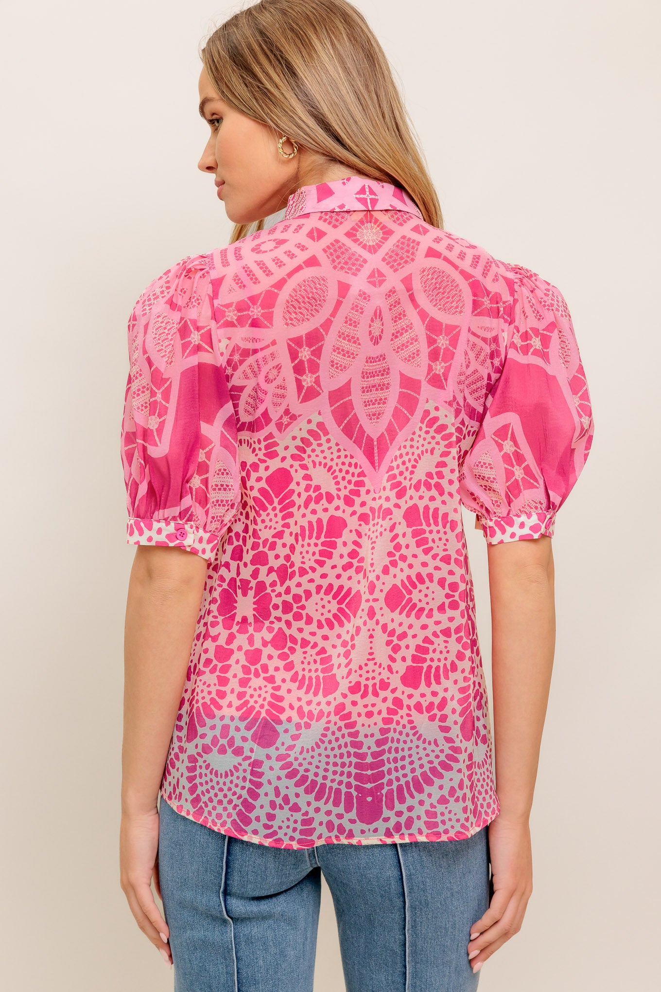 A printed woven top featuring collar, button down, short puff sleeve and cami