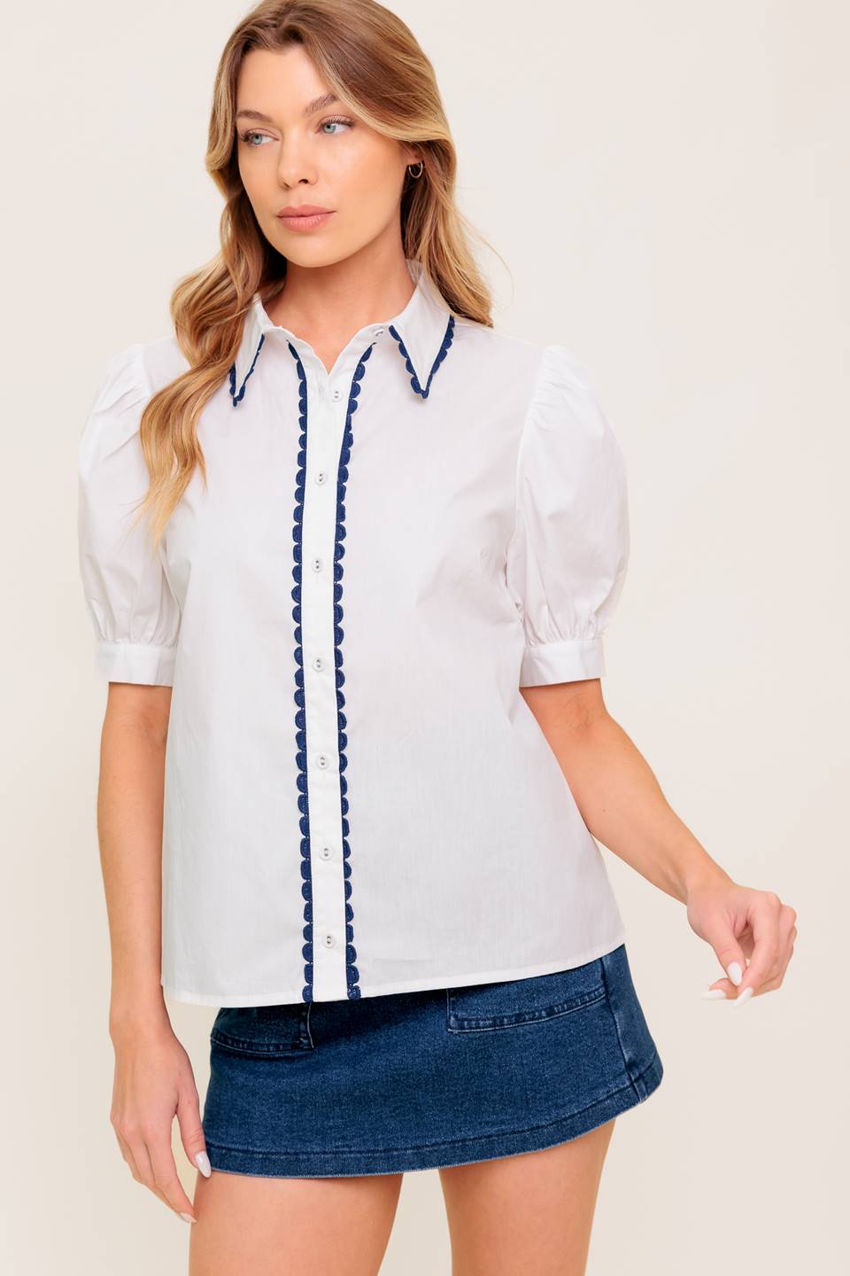 A solid woven top featuring collar, button down, short puff sleeve and laced edge.