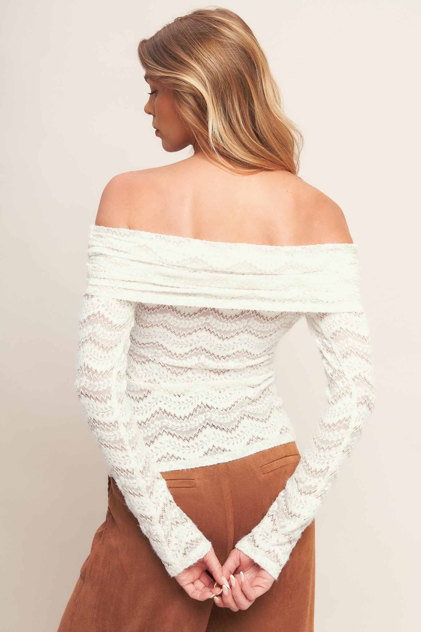 A knit lace top featuring off shoulder neckline and long sleeve
