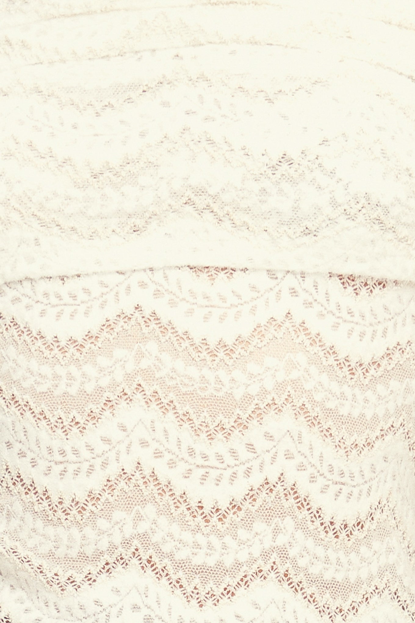 A knit lace top featuring off shoulder neckline and long sleeve