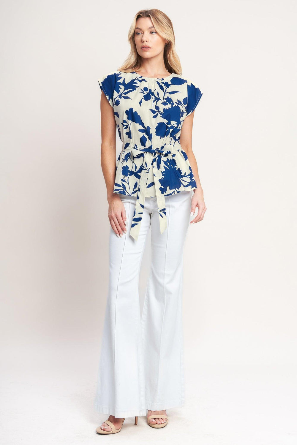 A printed woven top featuring round neckline, short sleeve, self sash tie and back neck button closure

Details:

Self: 100% Cotton

Size & Fit

-Model is 5`8" And Wearing Size Small
-Measurements Taken From Size Small
-Approx. Length: 24"