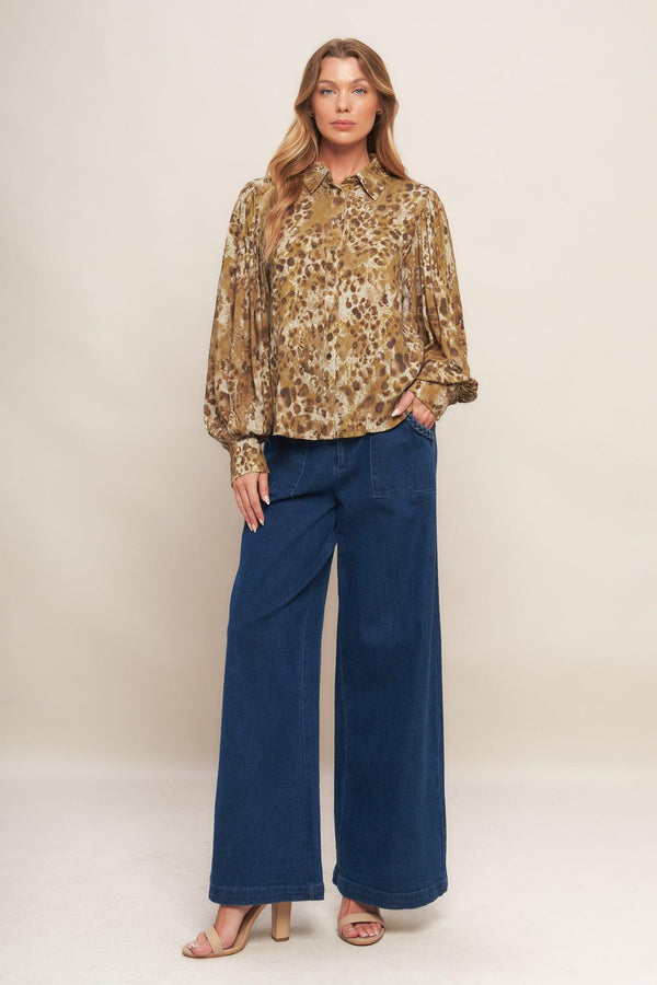 A printed woven top featuring collar, front button down and long blouson sleeve with cuff