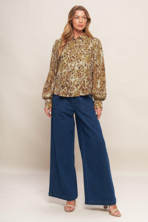 A printed woven top featuring collar, front button down and long blouson sleeve with cuff