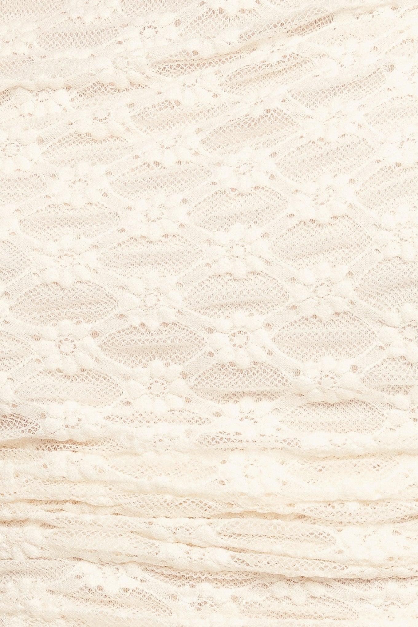 A stretch knit lace top with long sleeve and back neck button closure