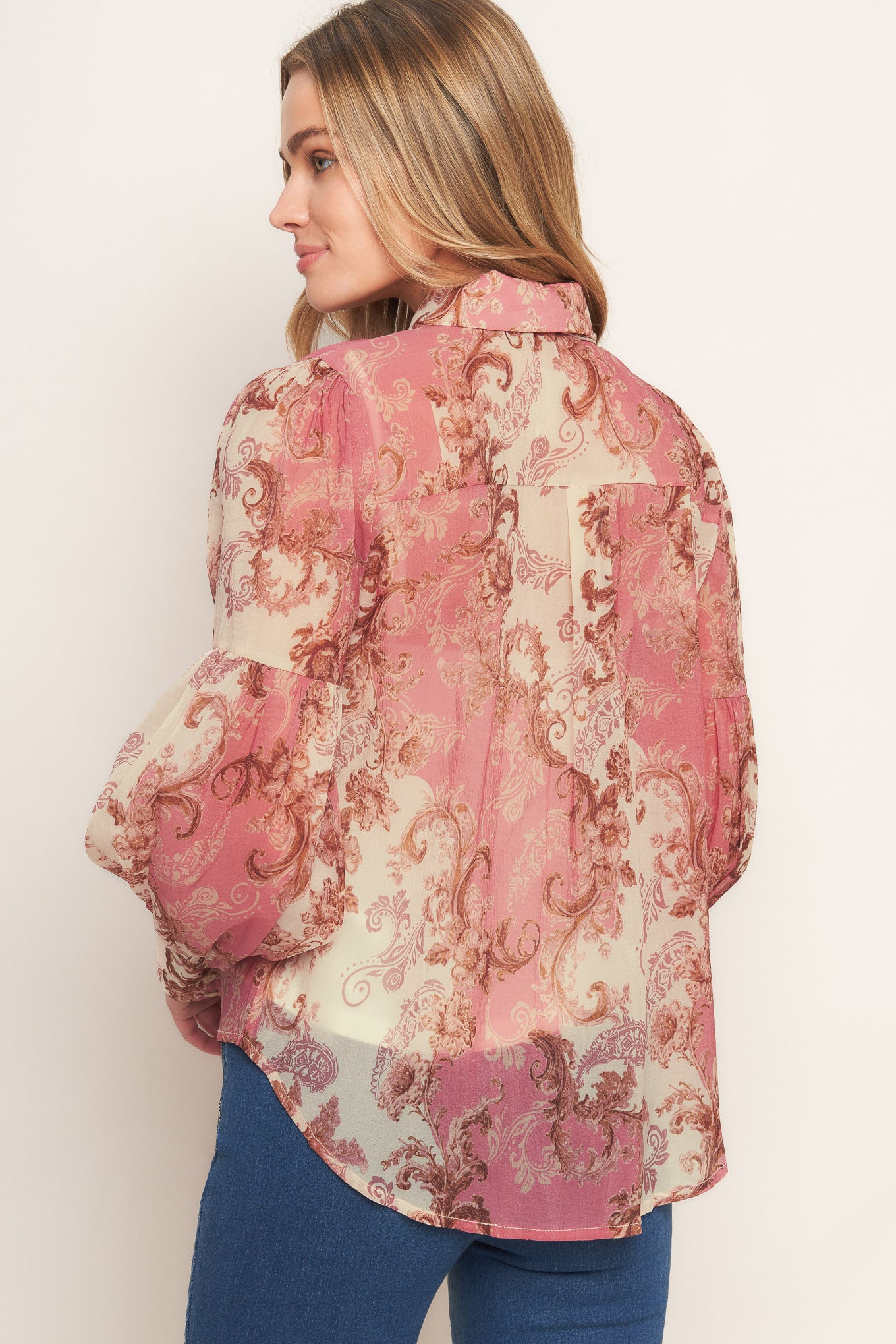 A printed woven top featuring collar, button down, neck tie and long lantern sleeve