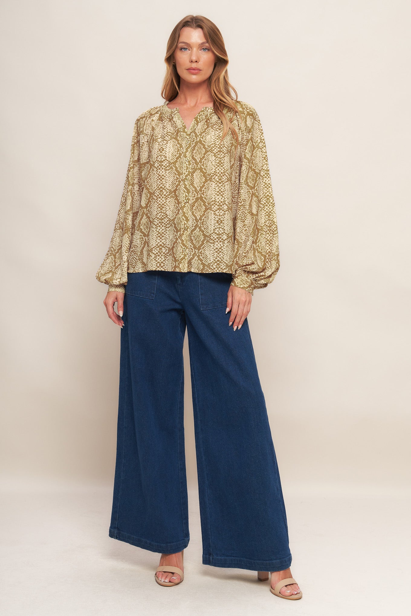A printed woven top with round neckline, long sleeve and front button down