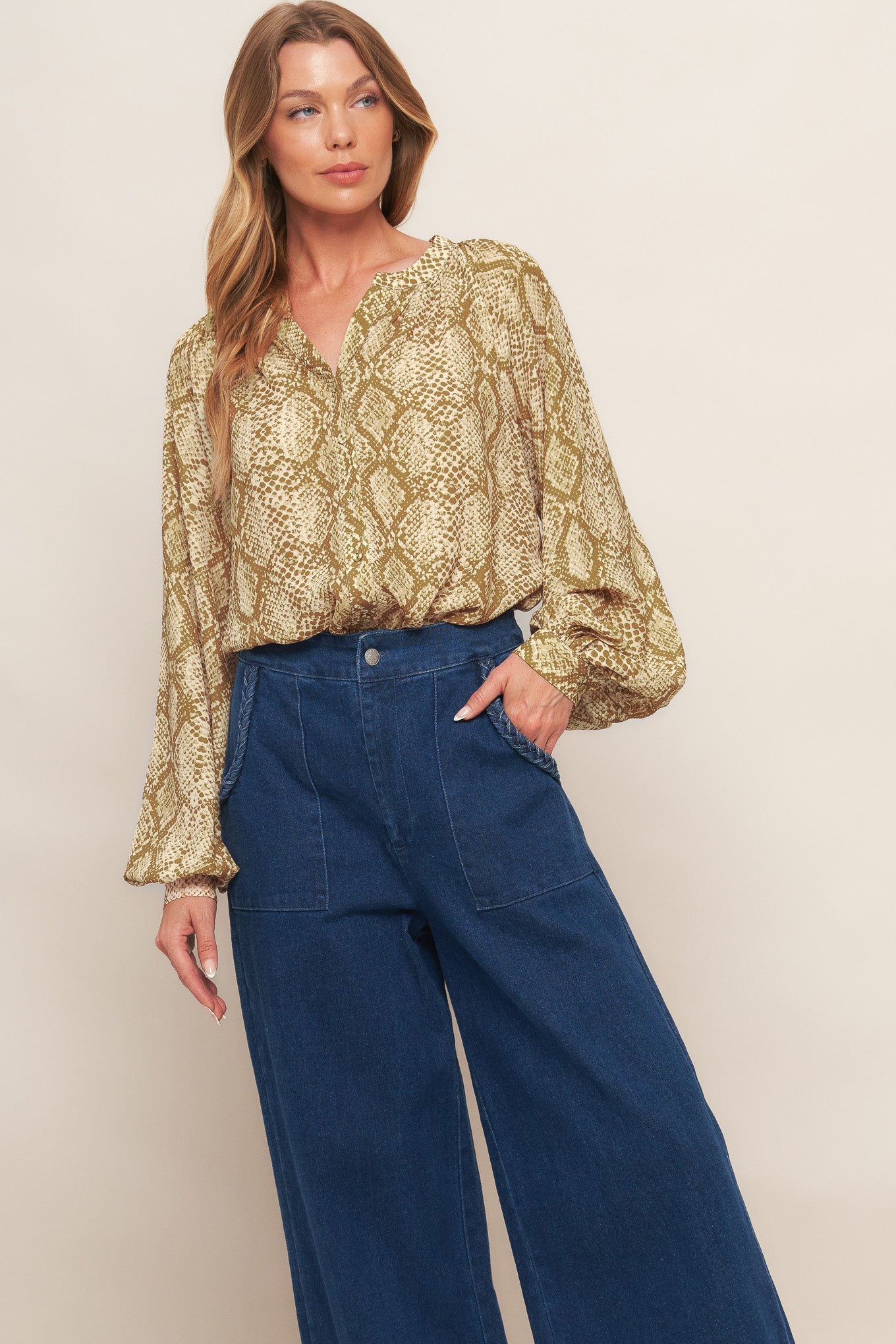 A printed woven top with round neckline, long sleeve and front button down
