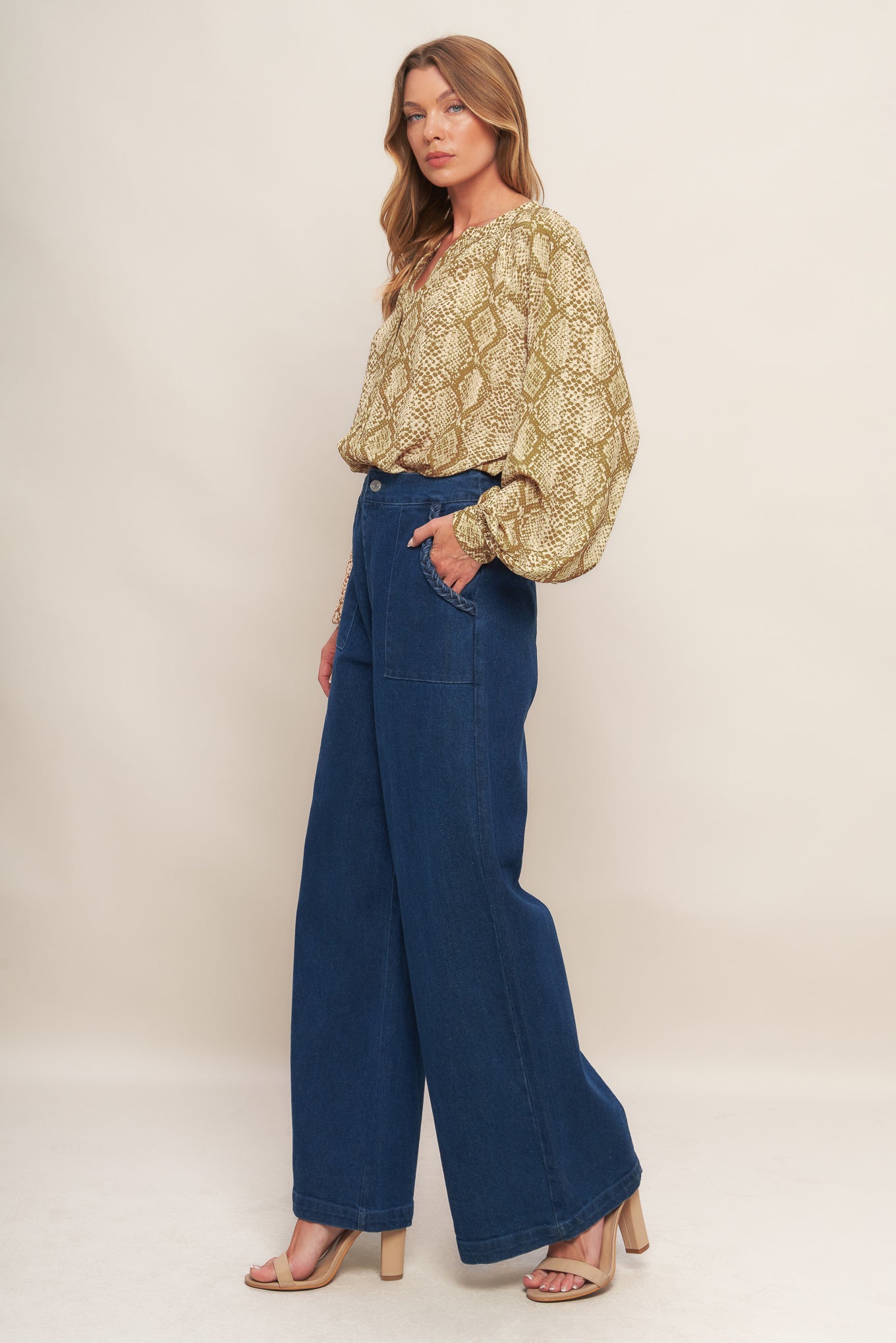 A printed woven top with round neckline, long sleeve and front button down