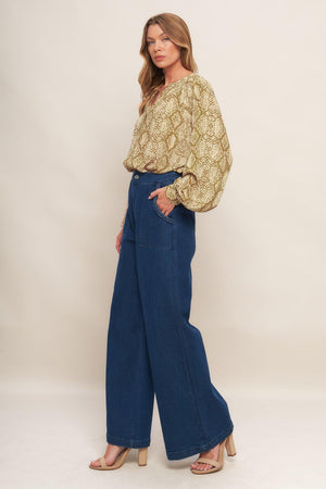A printed woven top with round neckline, long sleeve and front button down
