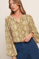 A printed woven top with round neckline, long sleeve and front button down
