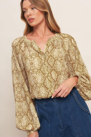 A printed woven top with round neckline, long sleeve and front button down