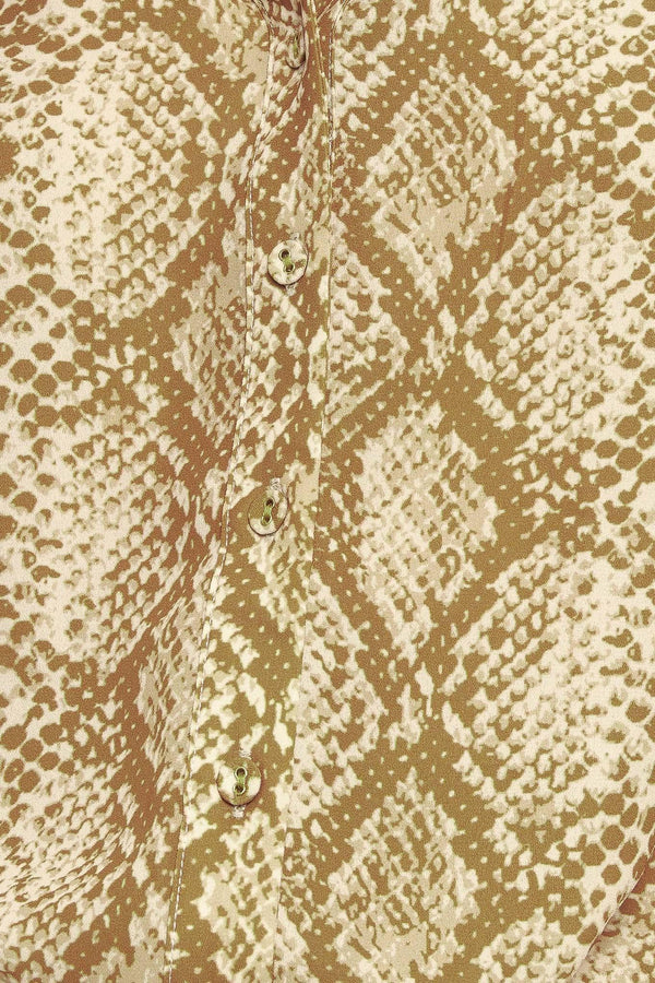 A printed woven top with round neckline, long sleeve and front button down
