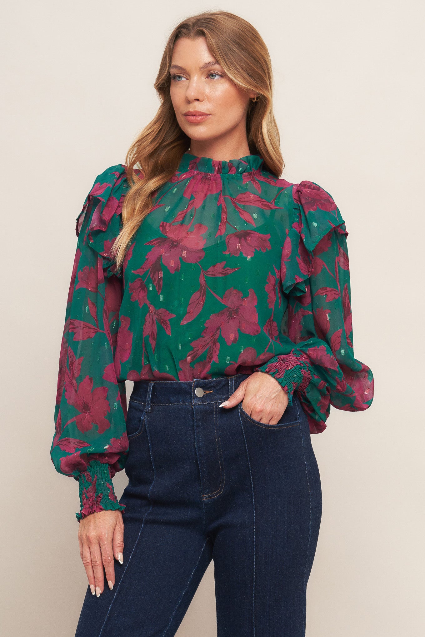 A printed woven top featuring high ruffled neckline, long sleeve with ruffed shoulder, back neck button closure and cami
