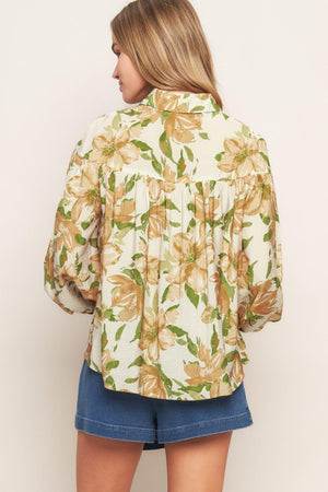 A printed woven top featuring collar, button down and long sleeve