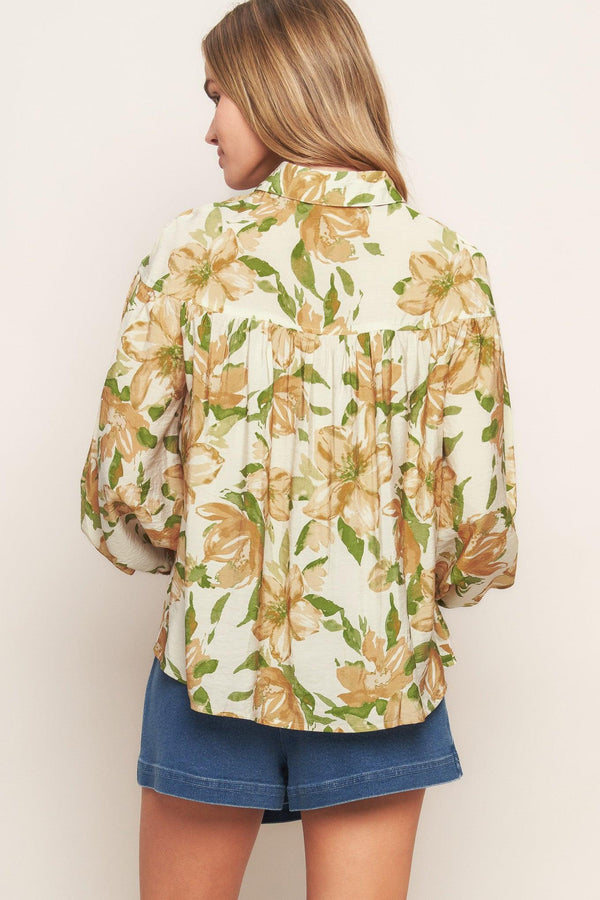 A printed woven top featuring collar, button down and long sleeve
