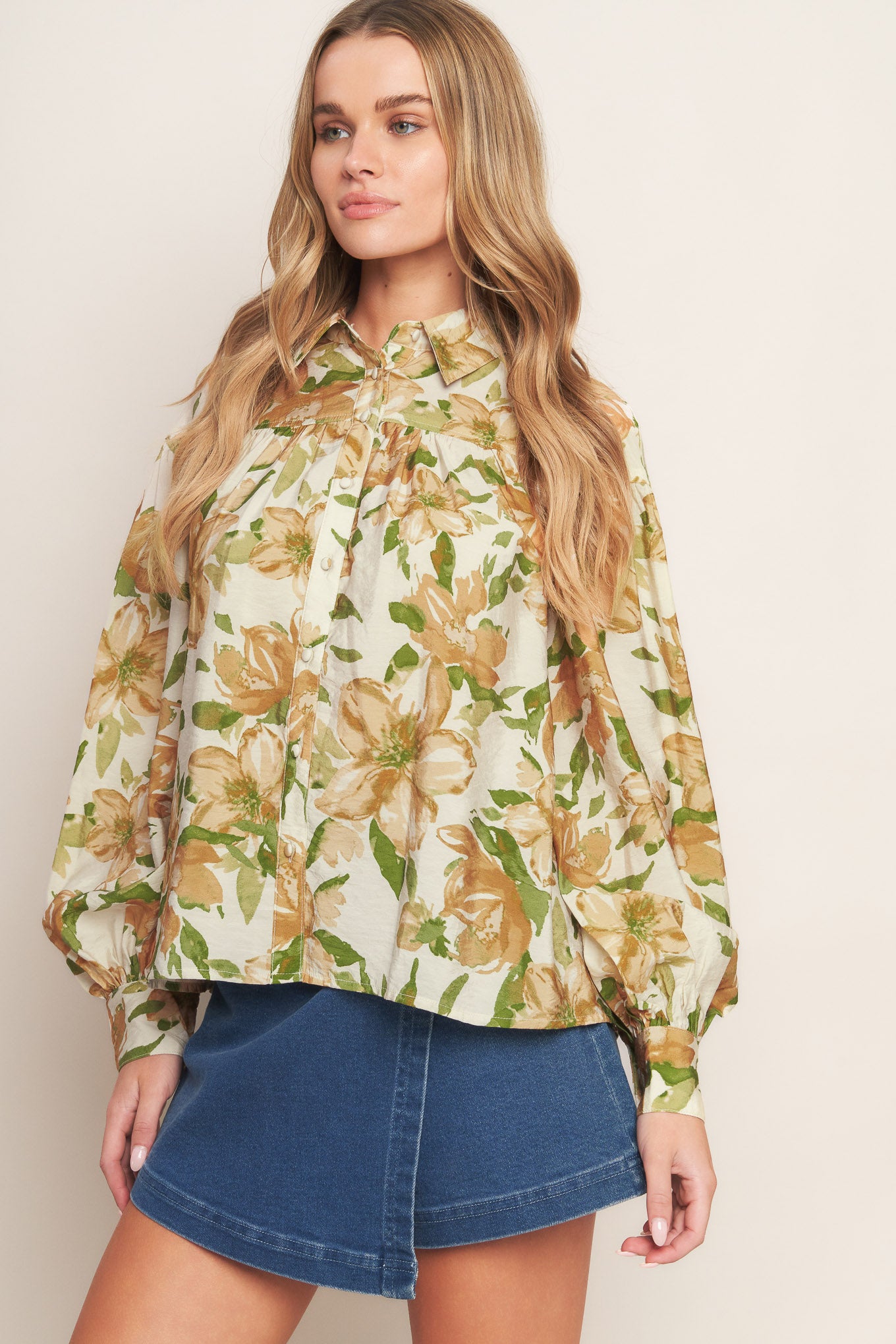 A printed woven top featuring collar, button down and long sleeve