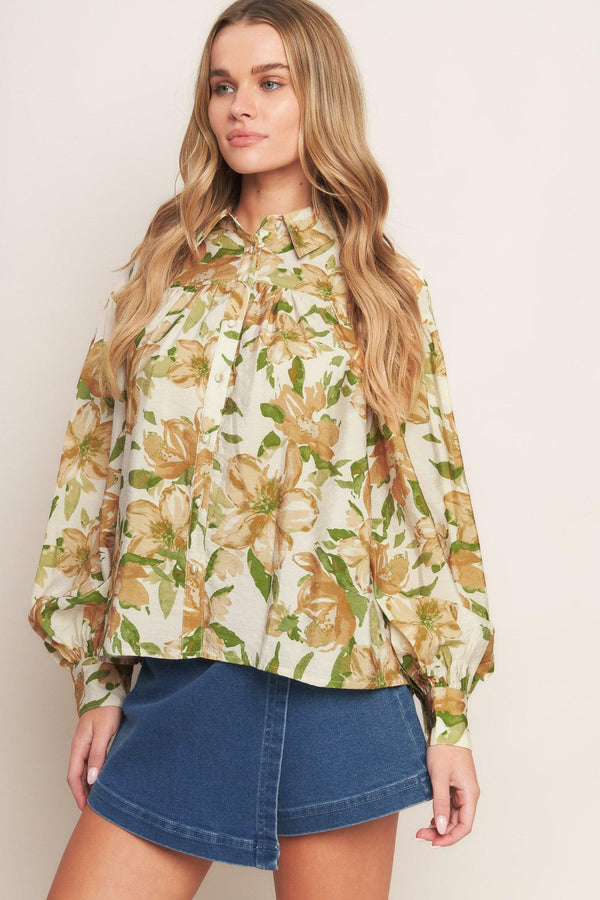 A printed woven top featuring collar, button down and long sleeve