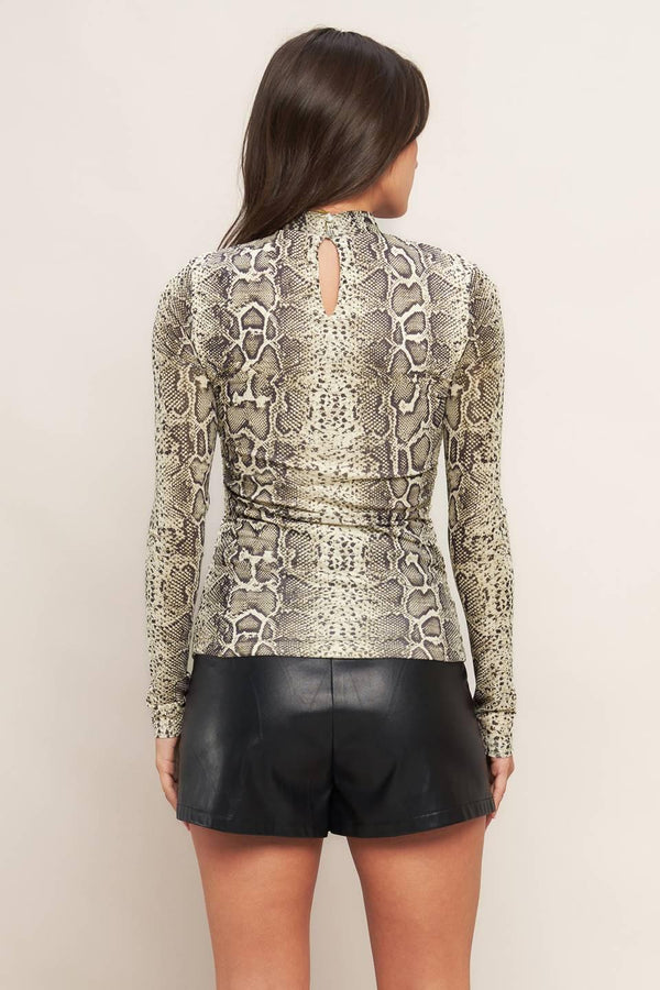 A printed knit top featuring high neckline, shirred front center and back neck button closure