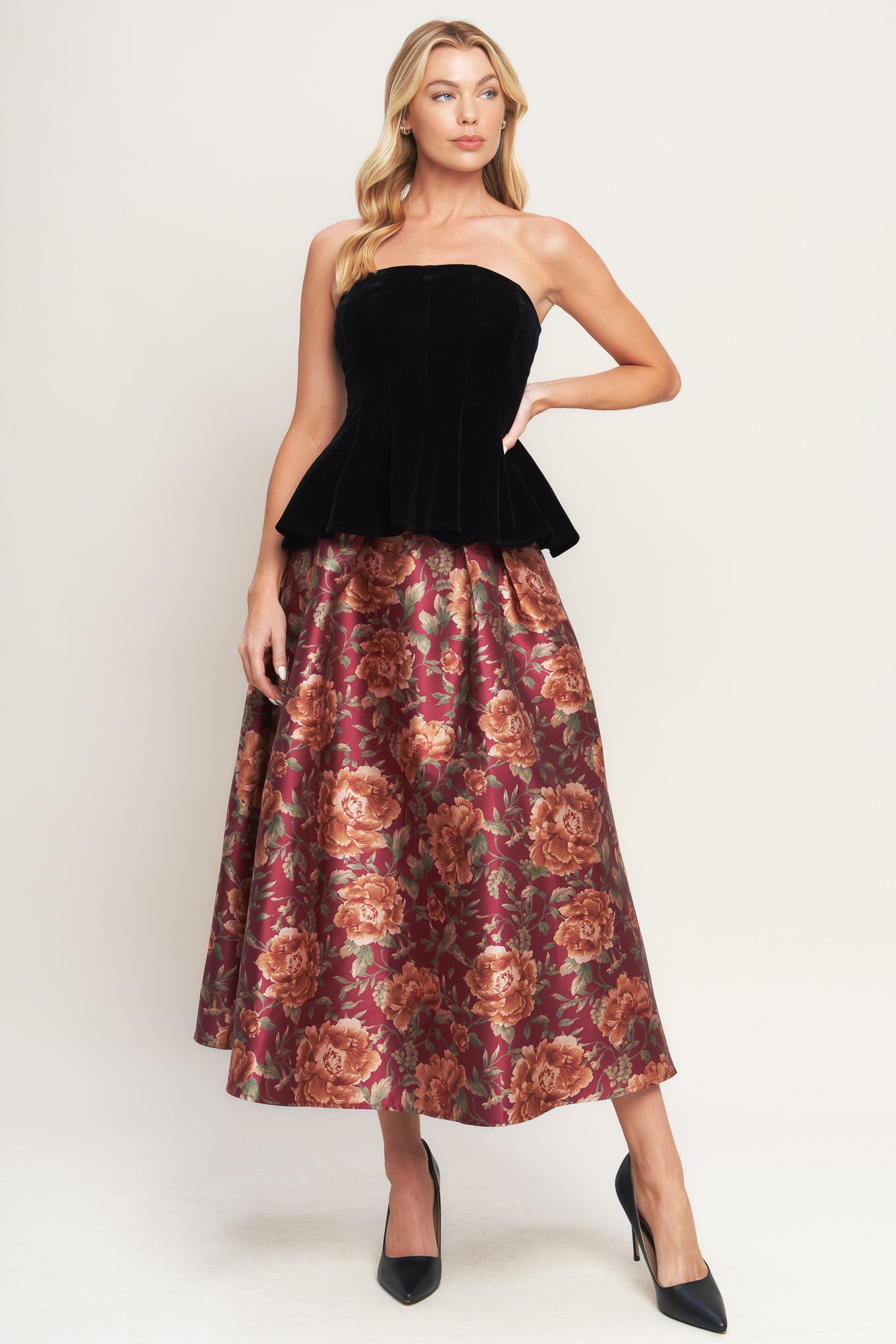 A velvet top featuring strapless, peplum and back zipper closure