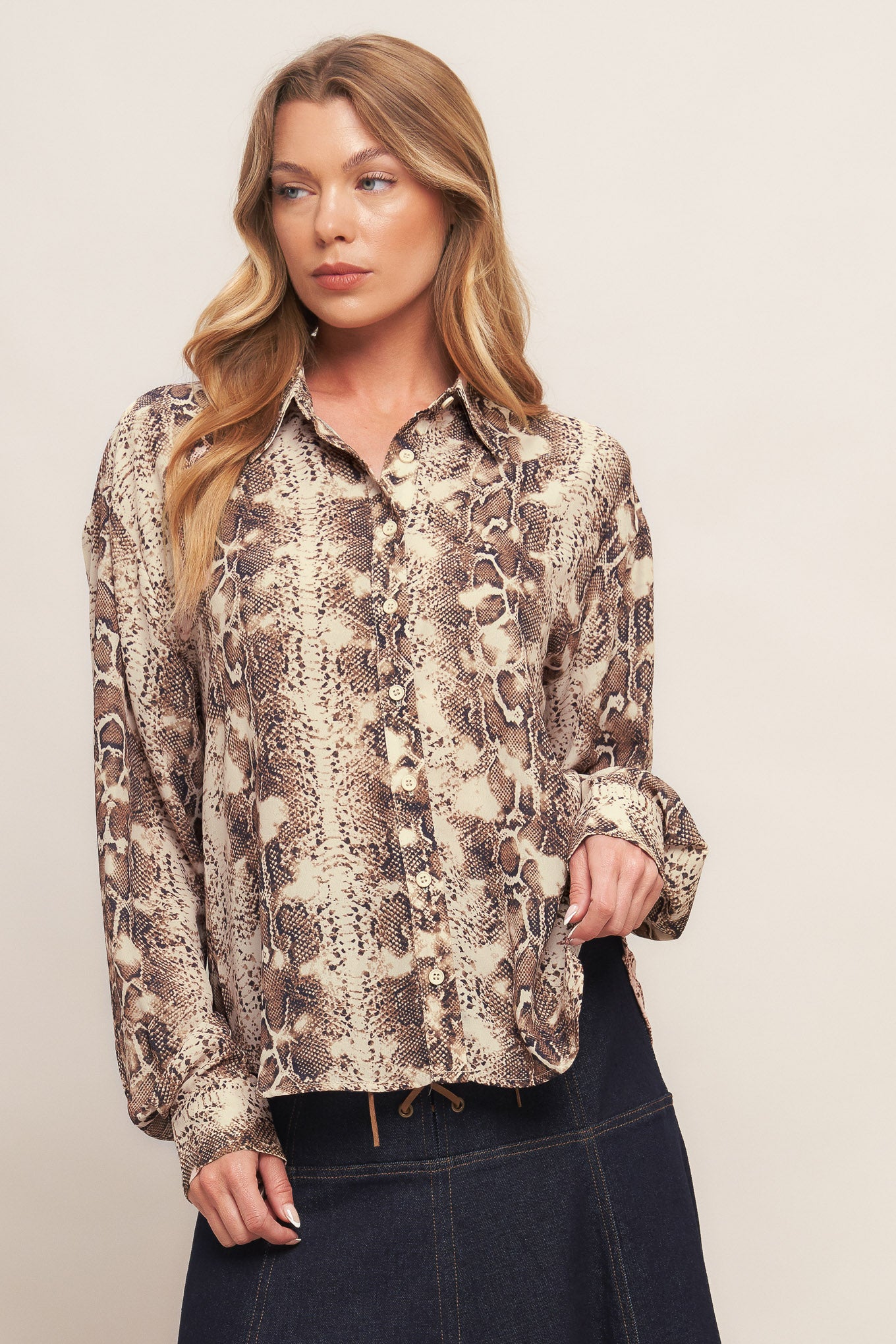 A printed woven top featuring collar, front button down and long sleeve with cuff