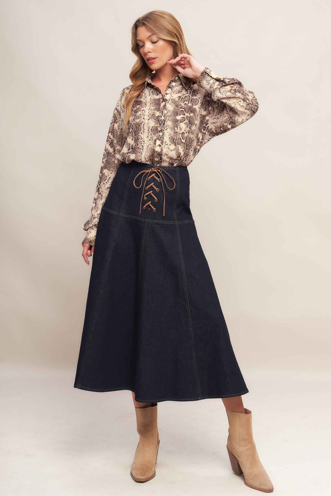 A printed woven top featuring collar, front button down and long sleeve with cuff