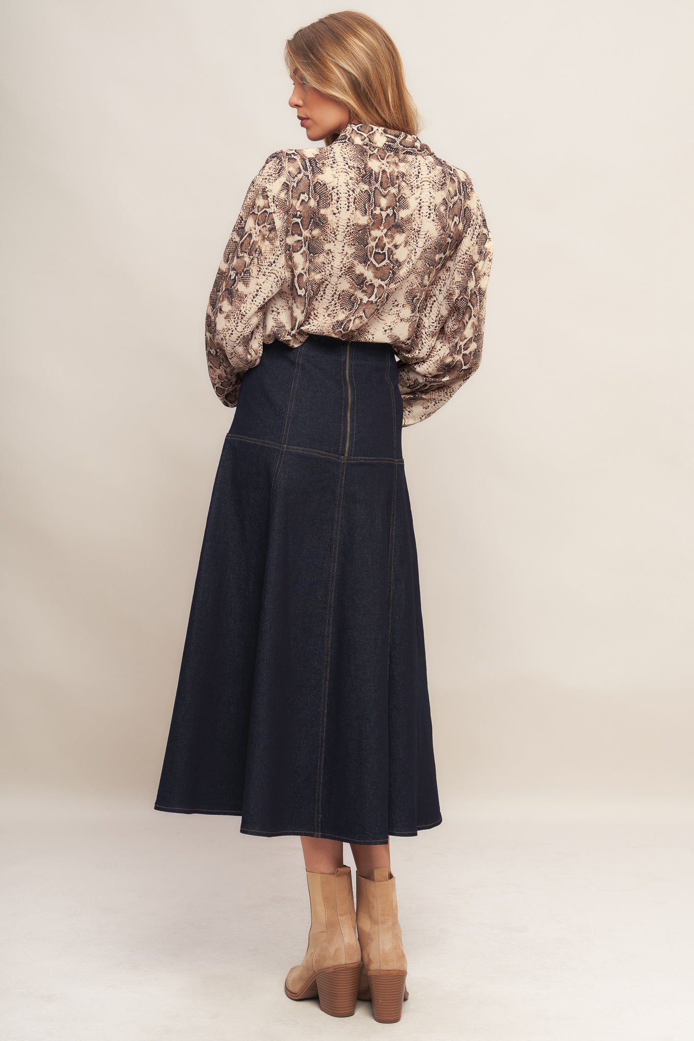 A printed woven top featuring collar, front button down and long sleeve with cuff