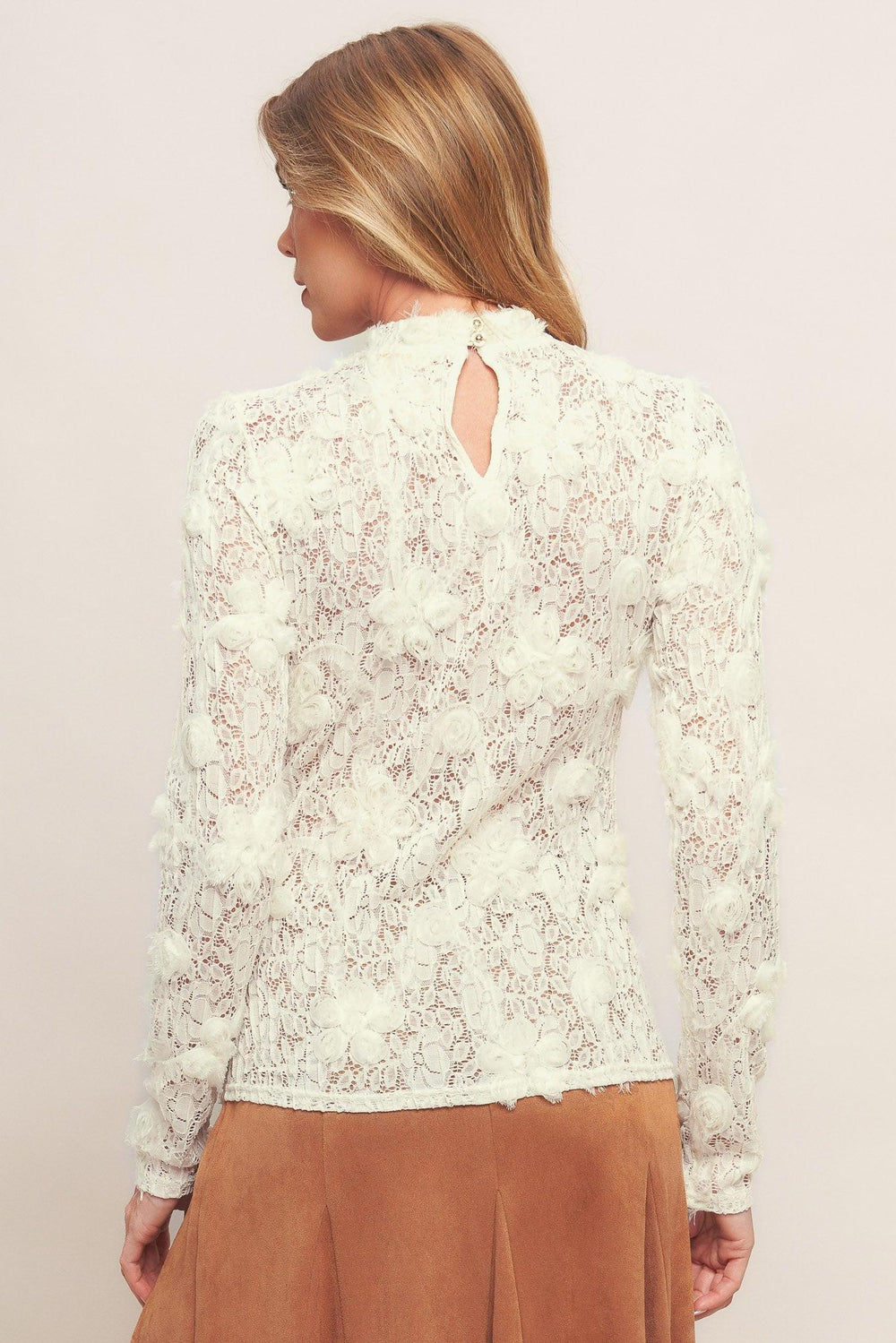 A textured light weight sweater top with mock neckline and back neck button closure