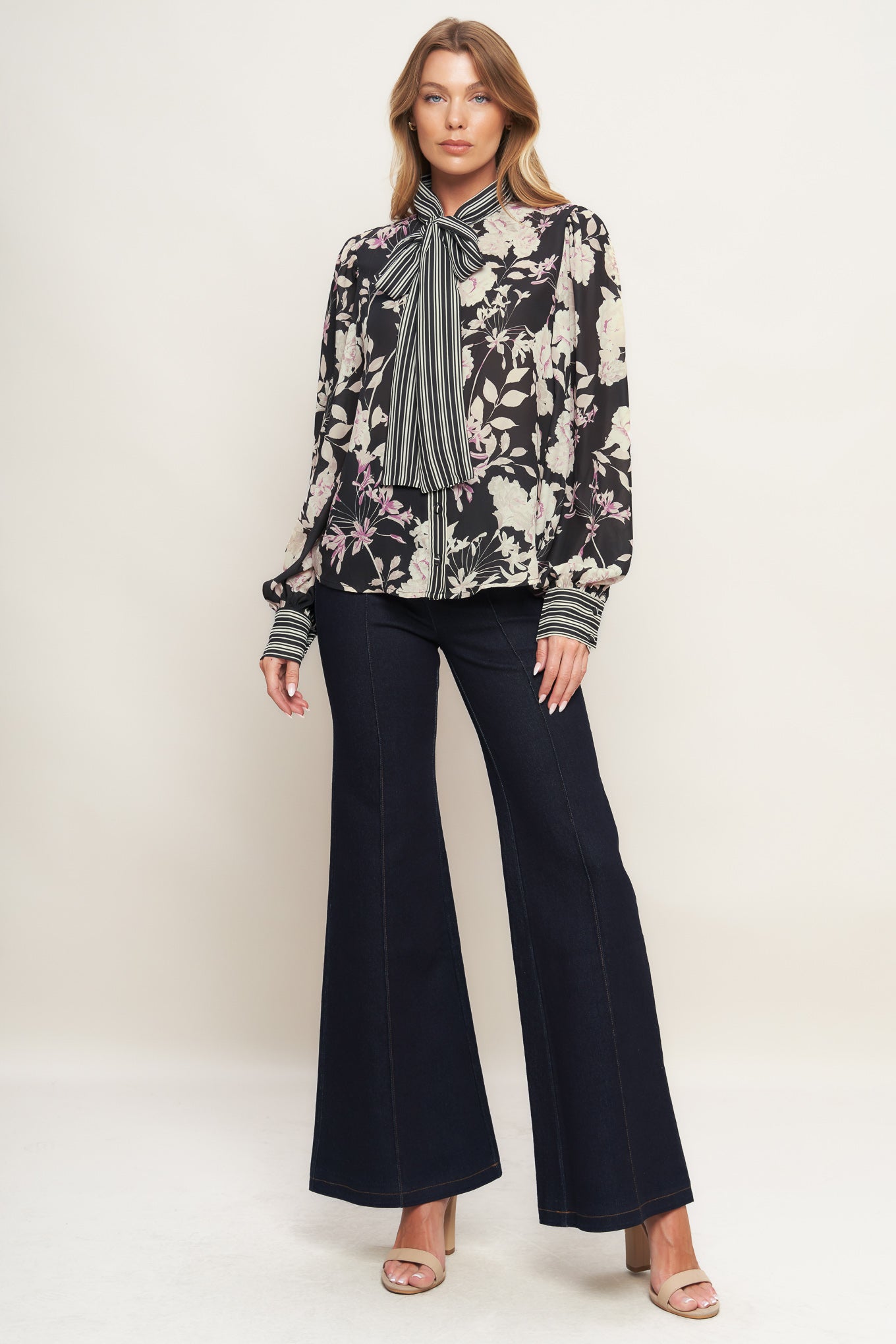 A printed woven top with front bow tie, long sleeve and button down