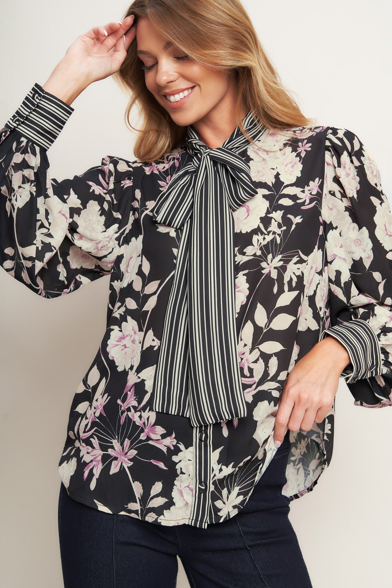A printed woven top with front bow tie, long sleeve and button down