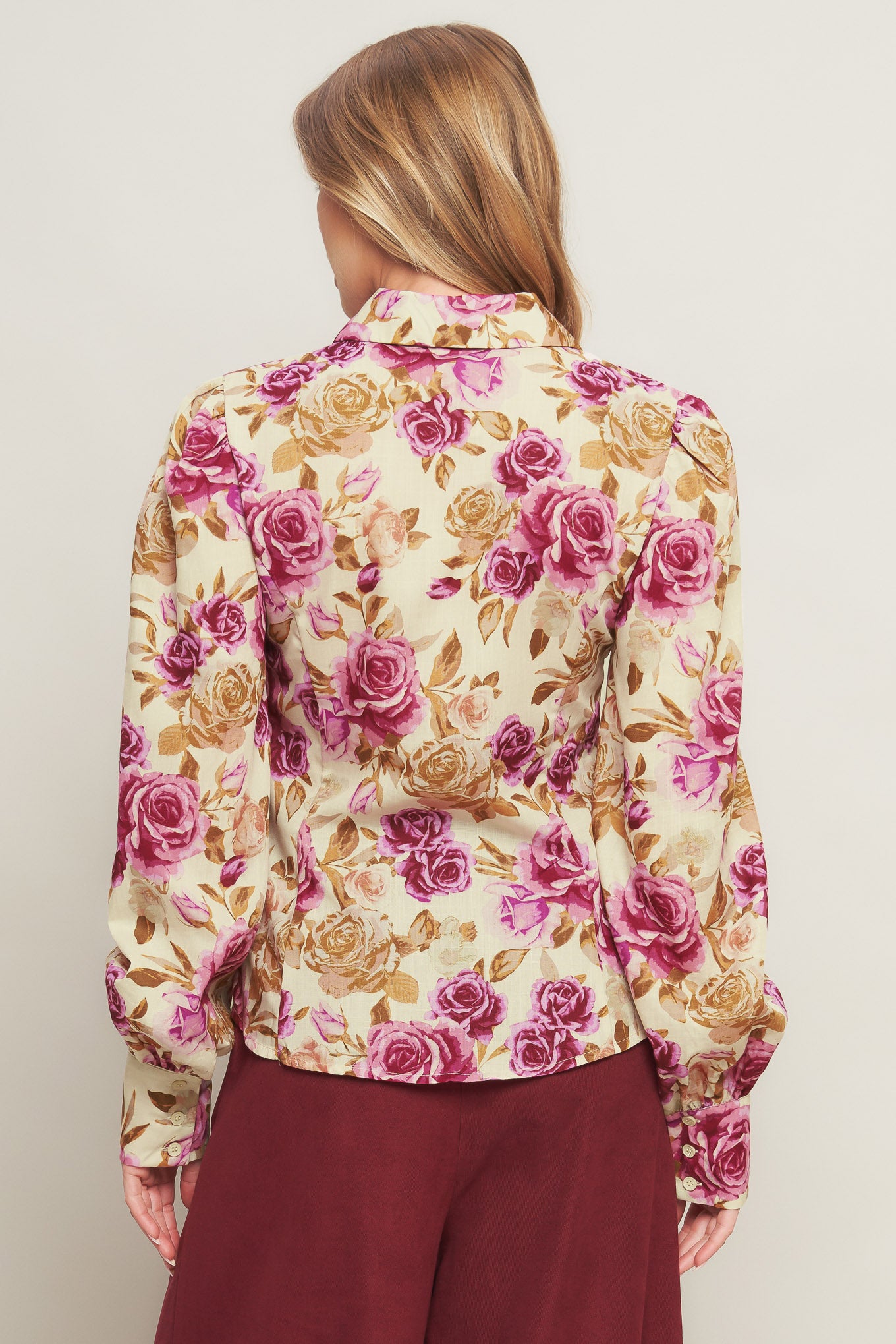 A printed woven top featuring collar, long sleeve and button down