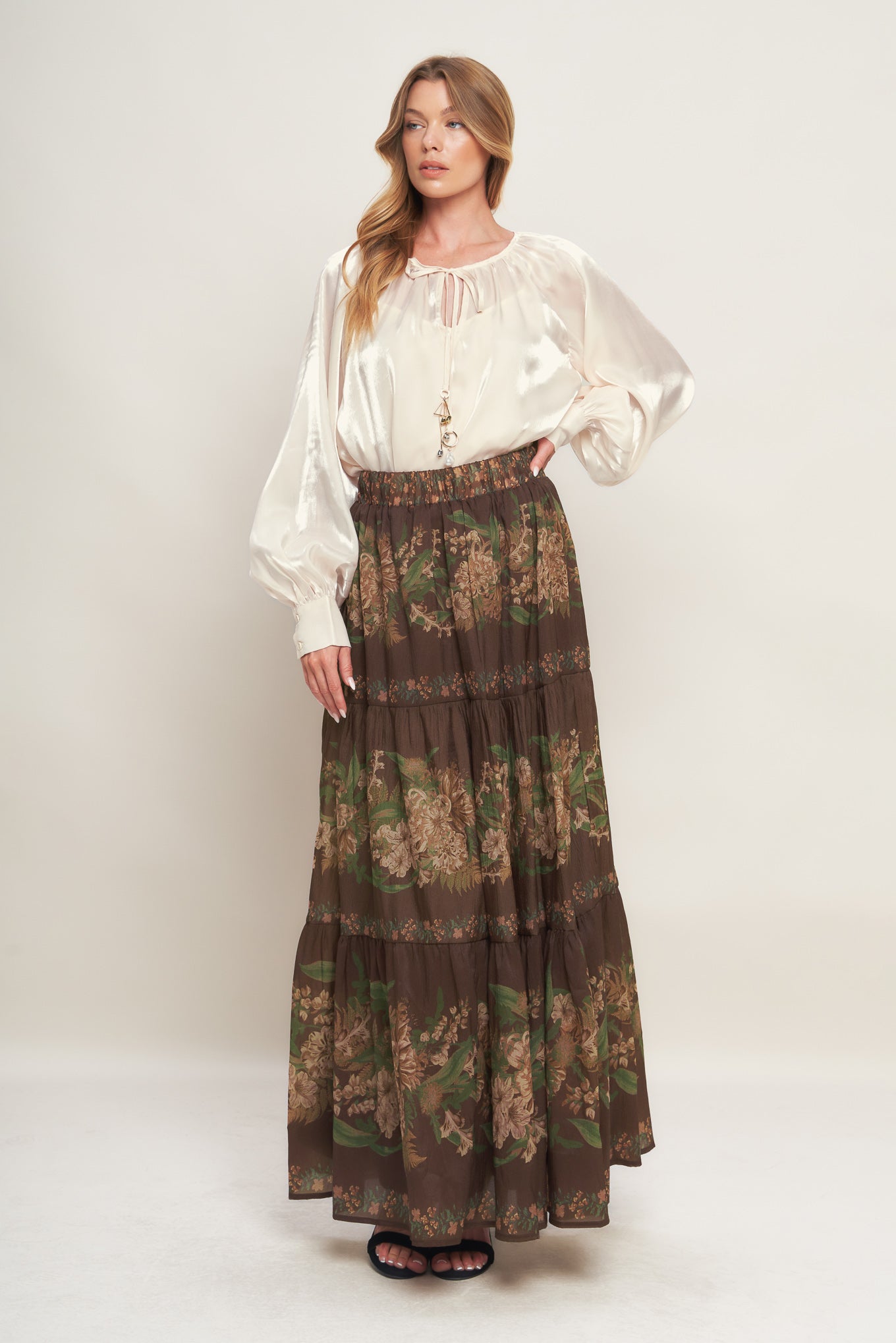 A solid sheen woven peasant top with front tie with embellishment, long sleeve with cuff and cami