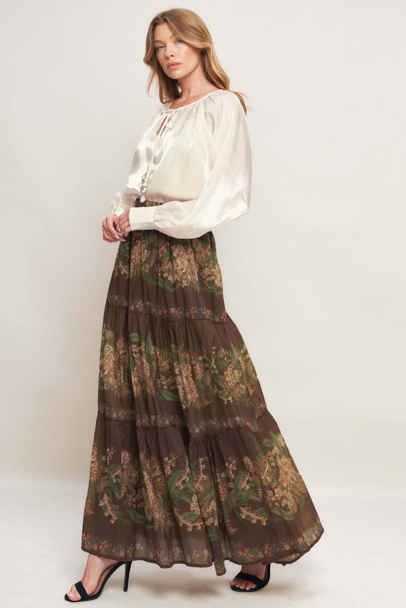 A solid sheen woven peasant top with front tie with embellishment, long sleeve with cuff and cami