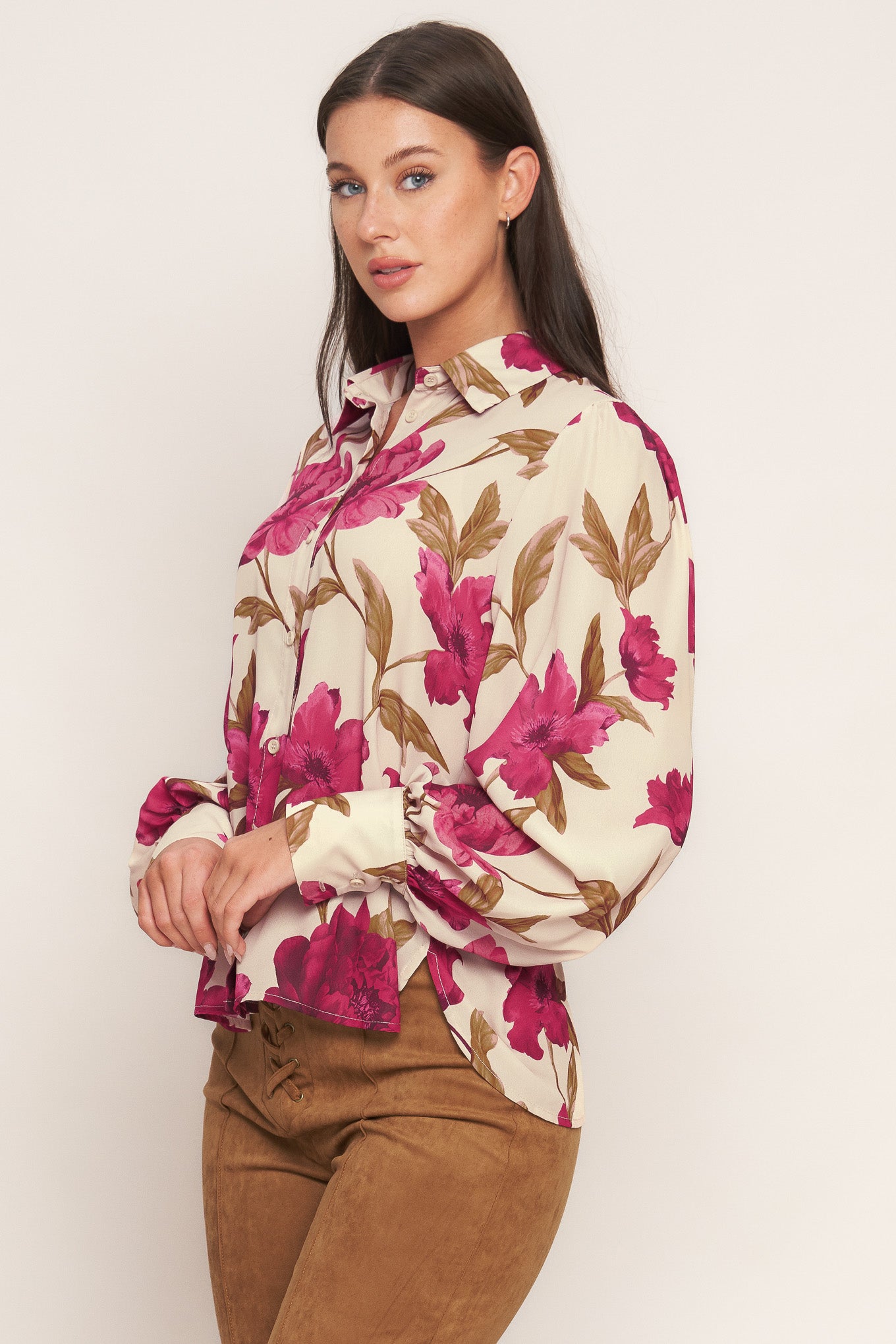 A printed woven top with front button down and long sleeve