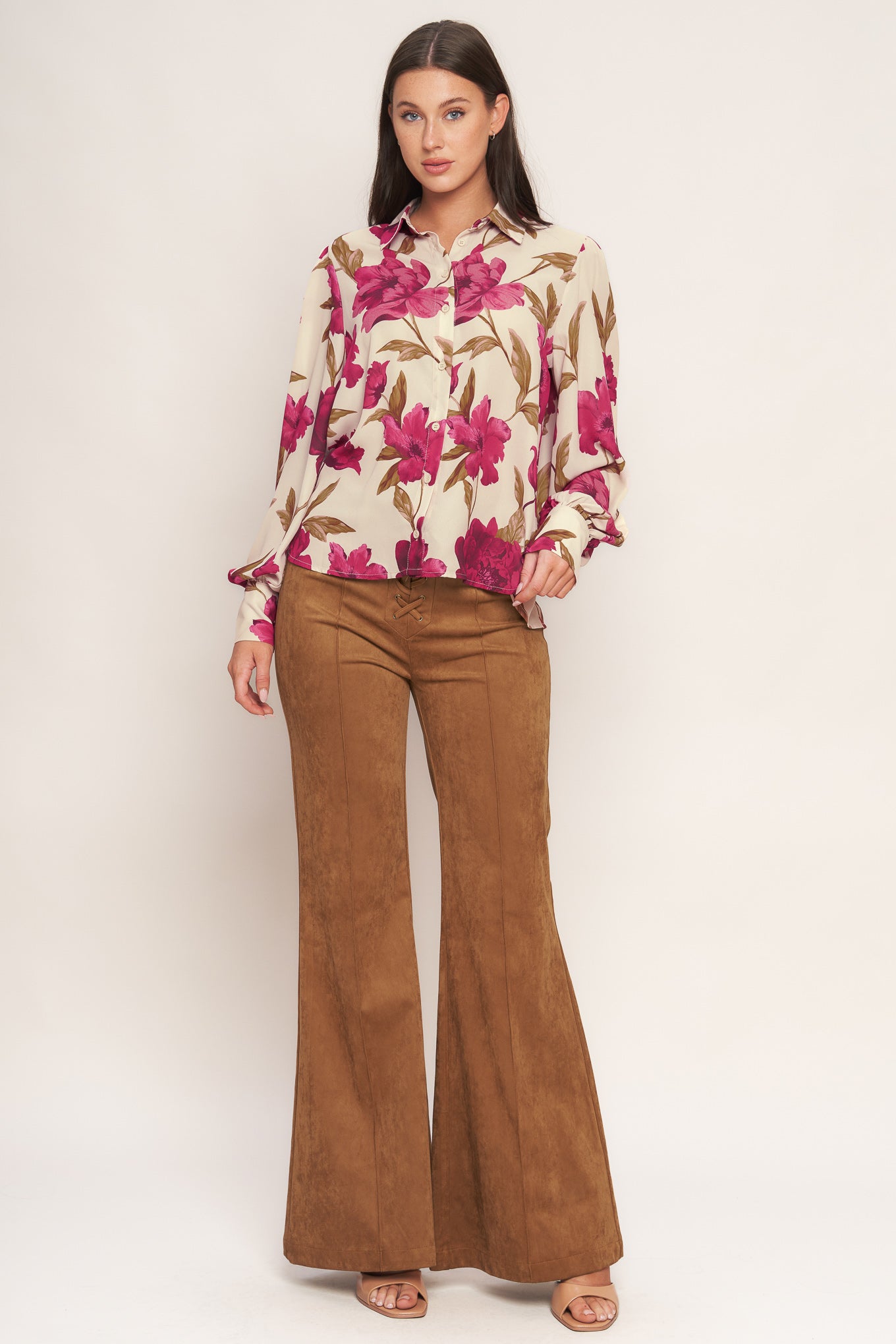 A printed woven top with front button down and long sleeve