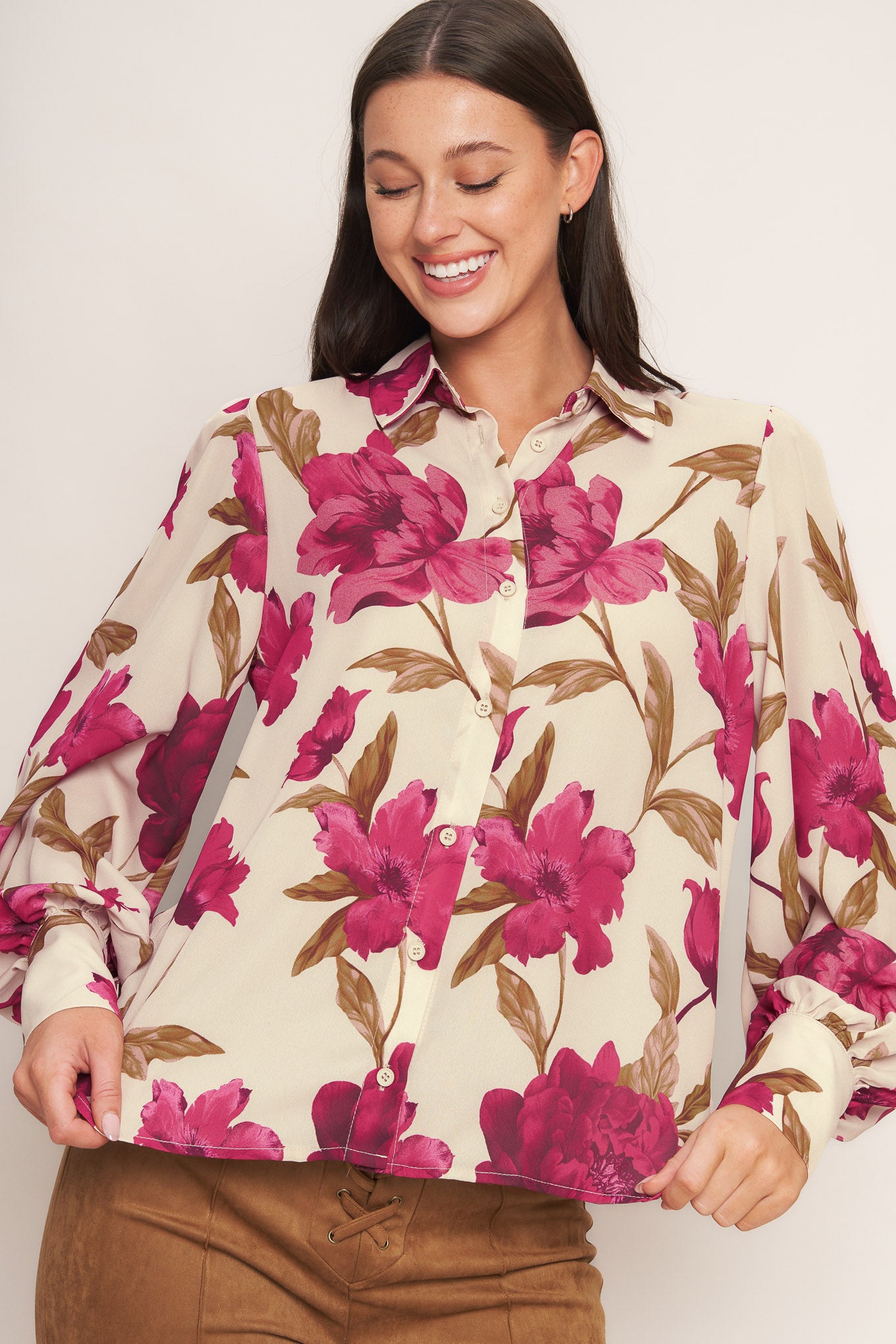 A printed woven top with front button down and long sleeve