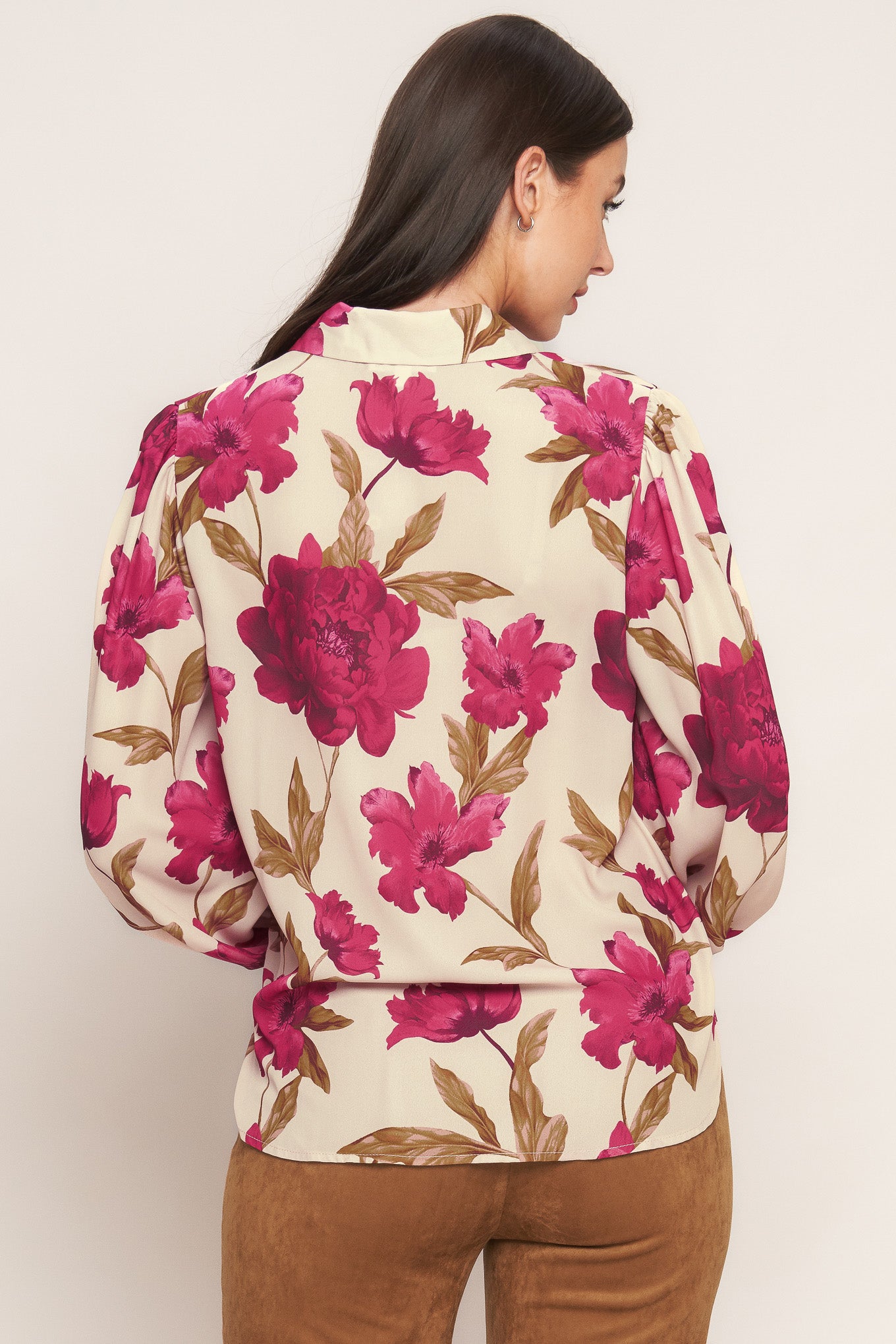 A printed woven top with front button down and long sleeve