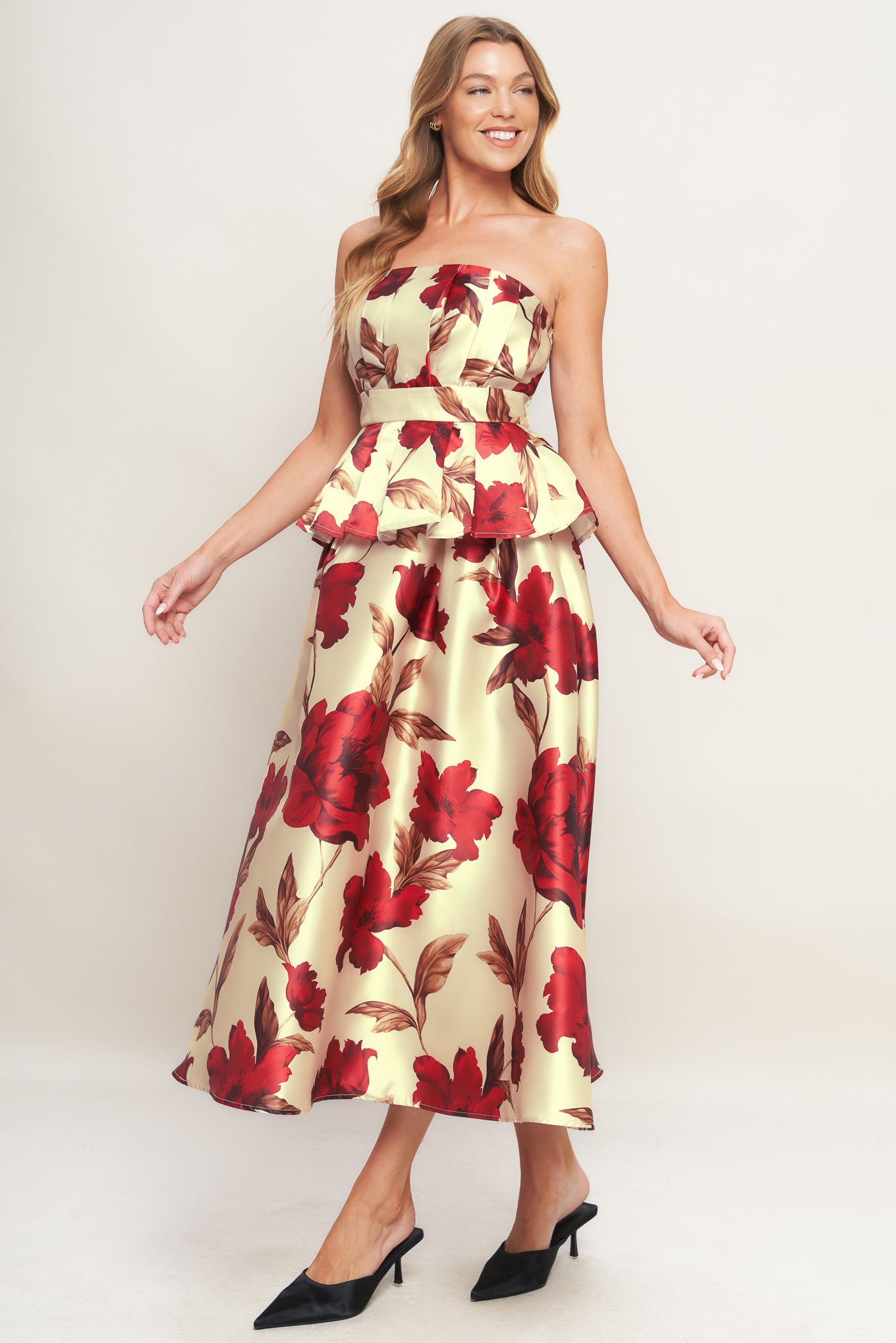 A printed woven top featuring strapless neckline, pleated body, peplum and smocked back bodice. 