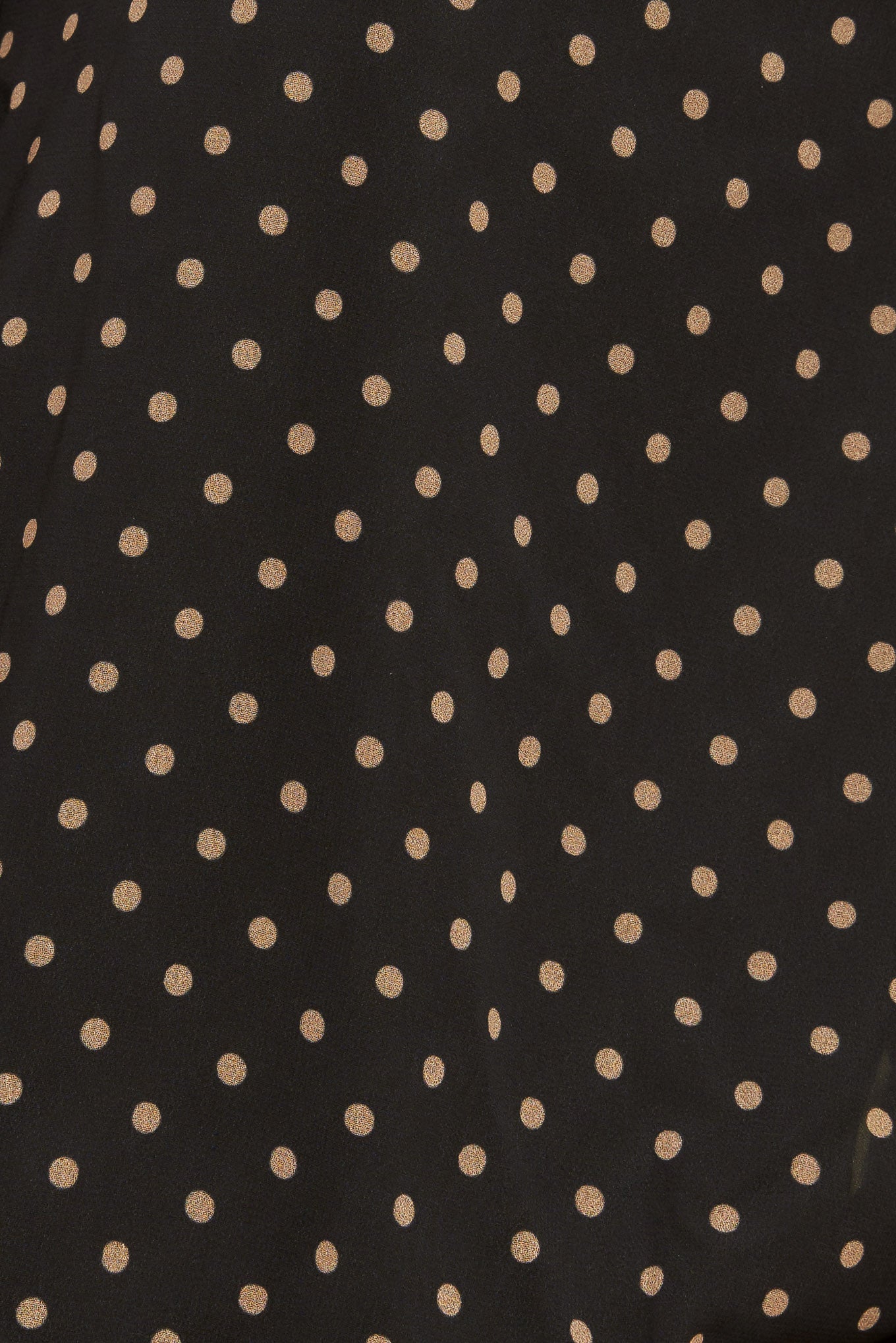 A woven dotted top featuring front bow tie and capelet.