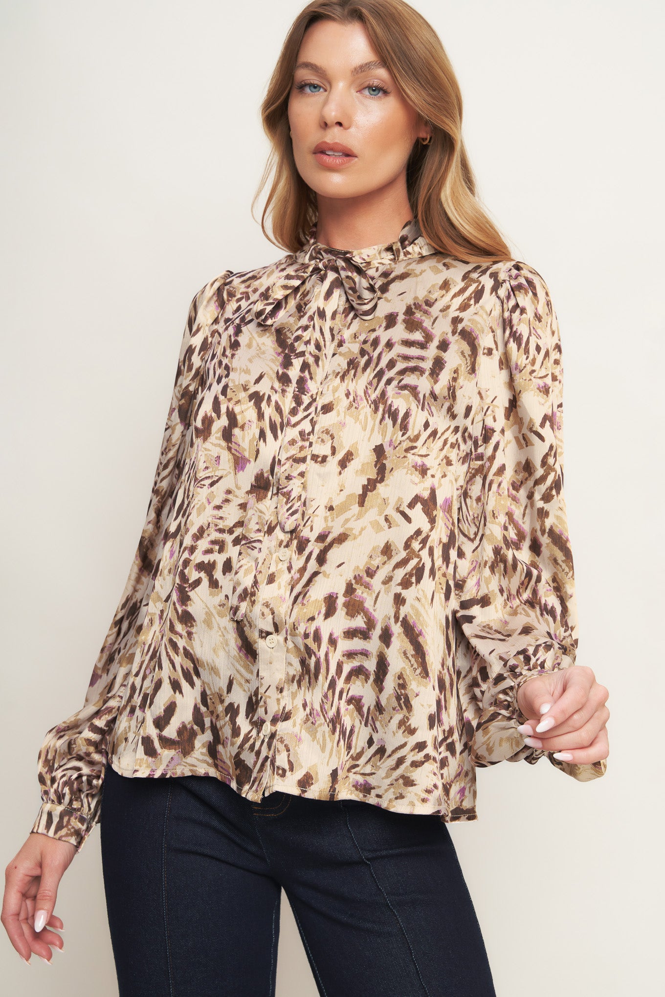 A printed woven top featuring round neckline with skinny tie, button down and long blouson sleeve