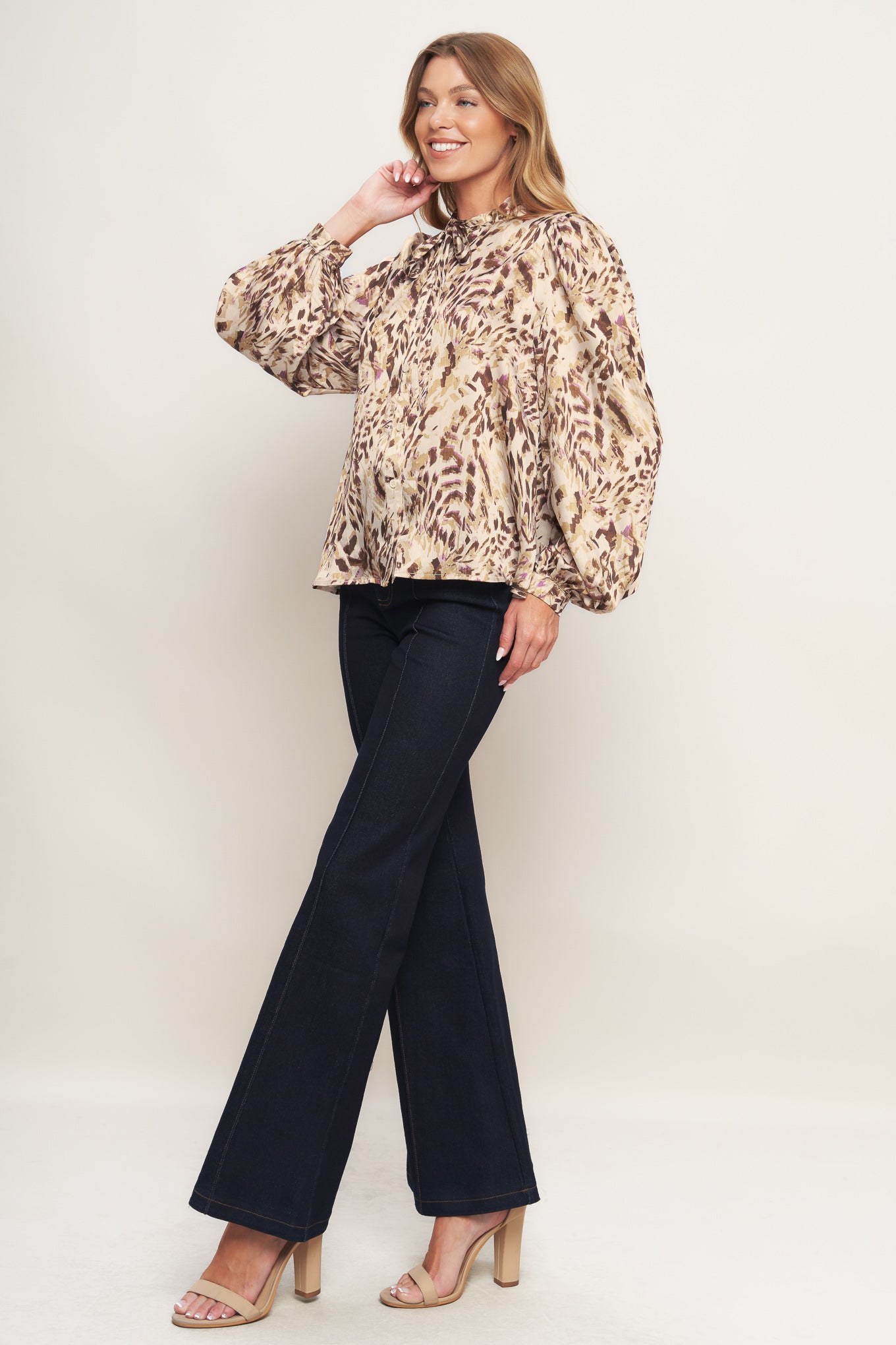 A printed woven top featuring round neckline with skinny tie, button down and long blouson sleeve