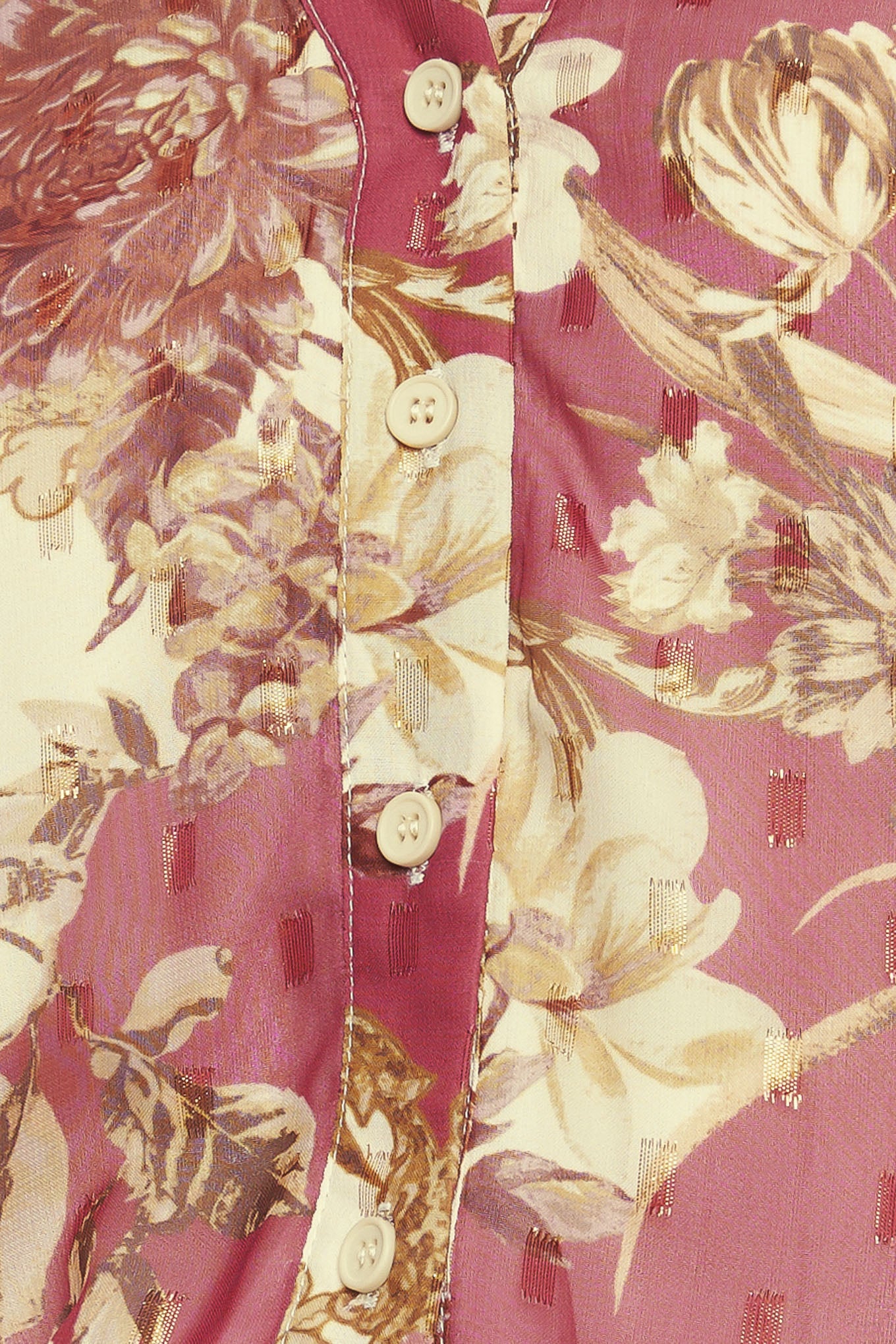 A printed woven top featuring round neckline with V front, long sleeve with cuff and button down closure