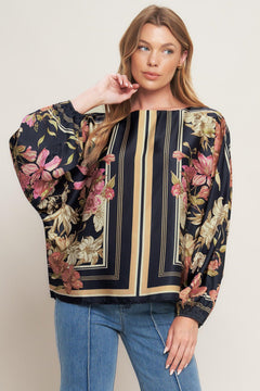 A printed woven top with wide neckline and long sleeve